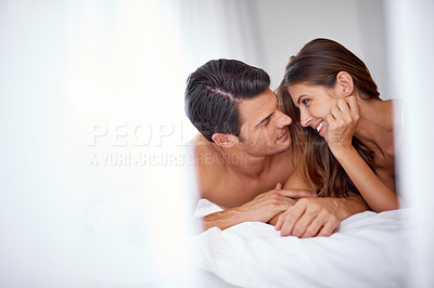 Buy stock photo Intimate, love and couple in the bedroom for conversation, relaxing and honeymoon in a hotel. Bonding, happy and young man and woman lying on a bed after valentines day, anniversary or a date