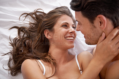 Buy stock photo Affection, intimate and couple laughing in the bedroom for sex, love and celebration of honeymoon. Relax, happy and funny man and woman bonding on an anniversary, valentines day or date on a bed