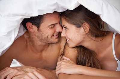 Buy stock photo Happy, love and couple in bed, waking up and bonding in a bedroom together, flirting and romantic. Romance, man and woman relax, intimate and resting at house for valentines day, anniversary or bond