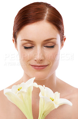Buy stock photo Scent, skincare and woman with flower, lily and natural beauty isolated on white studio background. Makeup, smell and model with floral cosmetics, eyes closed and glow for wellness with organic plant