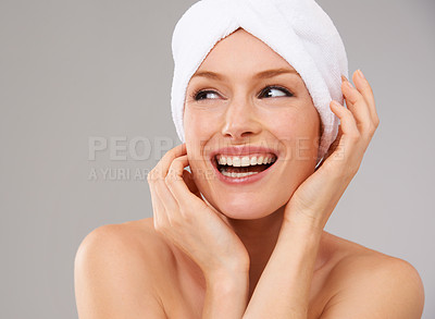 Buy stock photo Happy, woman and thinking about skincare for beauty and healthy dermatology in studio background. Girl, smile and model laughing with glow on skin from facial, cosmetics or towel for self care 