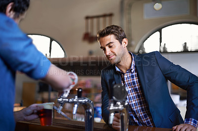 Buy stock photo Professional man at pub, order beer and relax on a break, leaning against countertop in bistro with alcohol drink. Hospitality industry, male business person at restaurant and enjoying social time