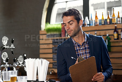 Buy stock photo Bar, stock or man with checklist for small business logistics, inventory or menu update on clipboard. Startup, reading pub info or manager writing sale price for an order in diner cafe or restaurant