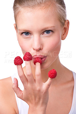 Buy stock photo Portrait, breakfast and raspberries on fingers of woman in studio isolated on white background for diet. Face, health and food on hand of young person eating fruit for weight loss, detox or nutrition