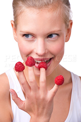 Buy stock photo Happy, thinking and woman eating raspberry, fingers and wellness isolated on white studio background. Smile,  organic or model with fruit or funny with nutrition, fresh or playful with health or diet