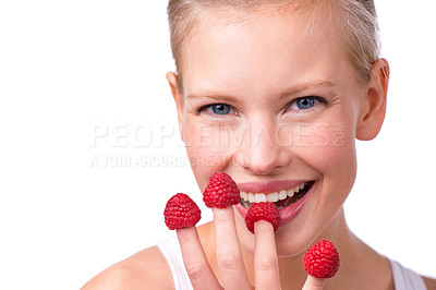 Buy stock photo Portrait, health and raspberries on fingers of woman in studio isolated on white background for diet. Face, smile and fruit with happy young person eating for weight loss, detox or nutrition
