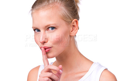 Buy stock photo Portrait of a beautiful young woman with her finger to her lips isolated on white