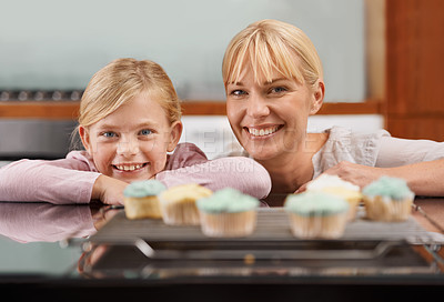 Buy stock photo Kitchen, cupcake and portrait with child and mom baking to relax in home together on holiday. Family, bonding and kid smile with mother, excited for eating cake, sweets or enjoy food in house