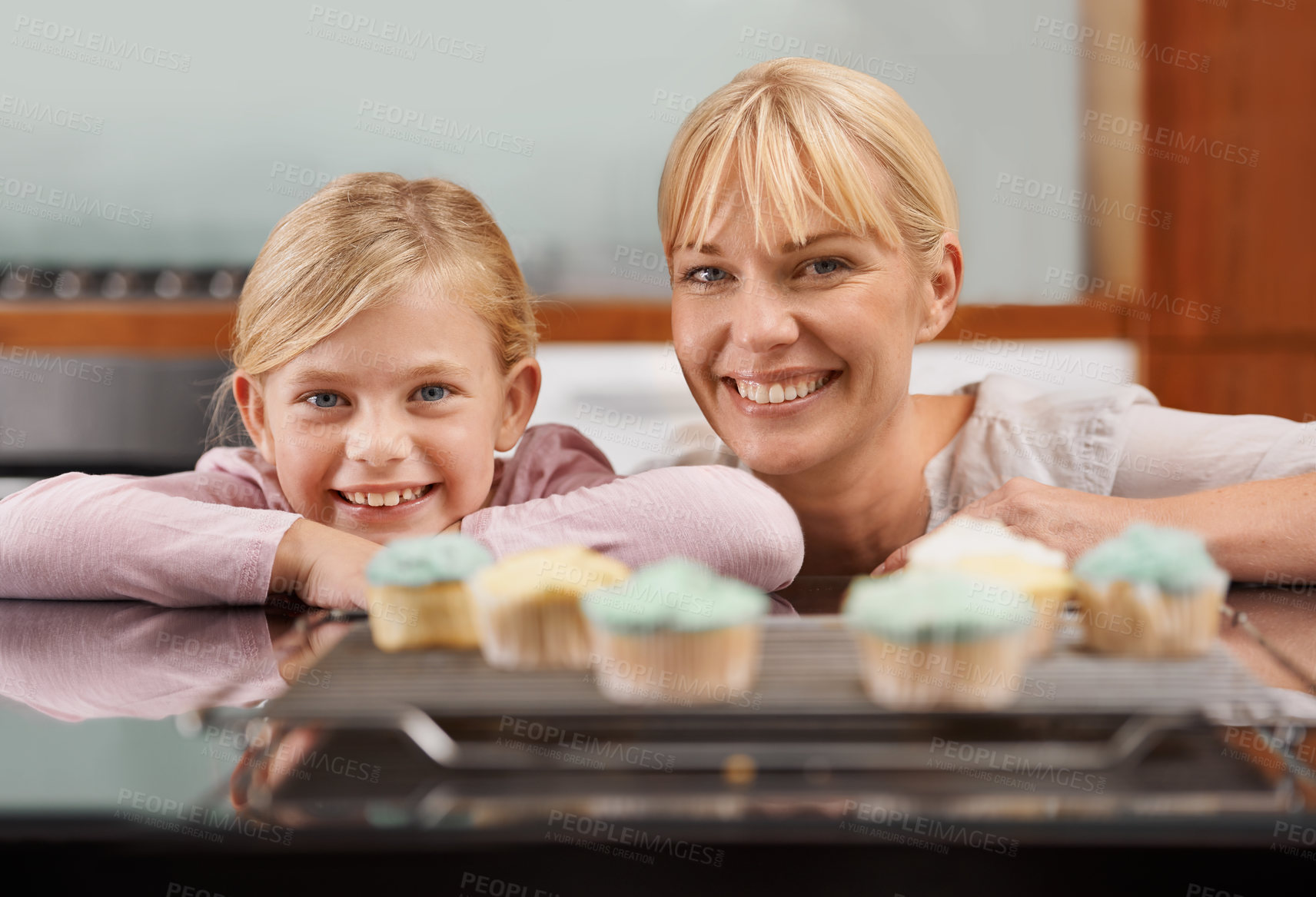 Buy stock photo Kitchen, cupcake and portrait with child and mom baking to relax in home together on holiday. Family, bonding and kid smile with mother, excited for eating cake, sweets or enjoy food in house