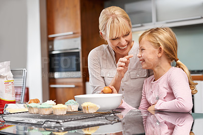 Buy stock photo Cropped shot of an attractive young woman baking with her adorable daughter