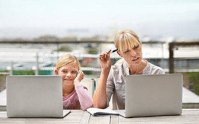 Buy stock photo Mother, child and laptop on a patio with elearning, work and internet with confused mama from pc. Tech, smile and mom with teaching and education app with young girl on a website for home school