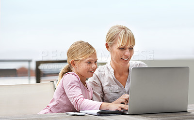 Buy stock photo Mother, child and laptop on a patio with elearning, game and internet with love, support and bonding. Tech, smile and mom with teaching and education app with young girl on a website for home school