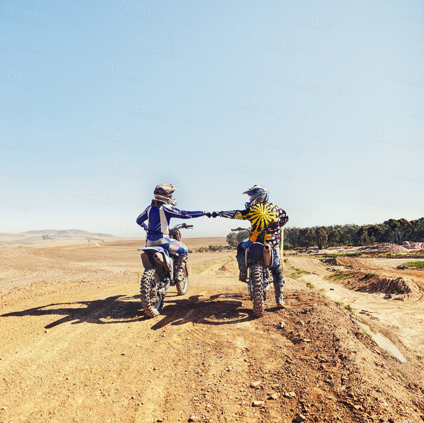 Buy stock photo Sport, teamwork or people on motorcycle outdoor on dirt road before racing, challenge or competition on mockup. Motocross, dirtbike driver and fist bump with helmet on offroad course for performance
