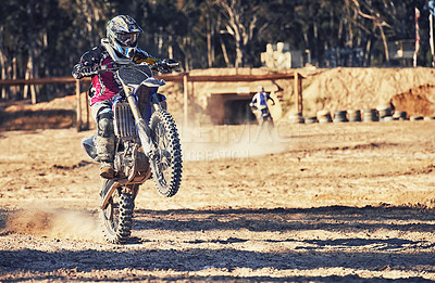 Buy stock photo Motorcycle, action and balance with person riding on dirt track, adrenaline and stunt for extreme sports outdoor. Competition, adventure and power with risk, speed and biker on motorbike for race