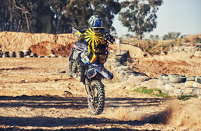 Buy stock photo Motorcycle, action and balance, person on race track for adrenaline and stunt with extreme sports outdoor. Competition, adventure and power with risk, biker riding on motorbike with speed and skill