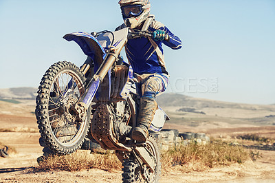 Buy stock photo Motorbike, action and balance, person with speed and skill for adrenaline and stunt with extreme sports outdoor. Competition, adventure and power with risk, biker riding on motorcycle with wheelie