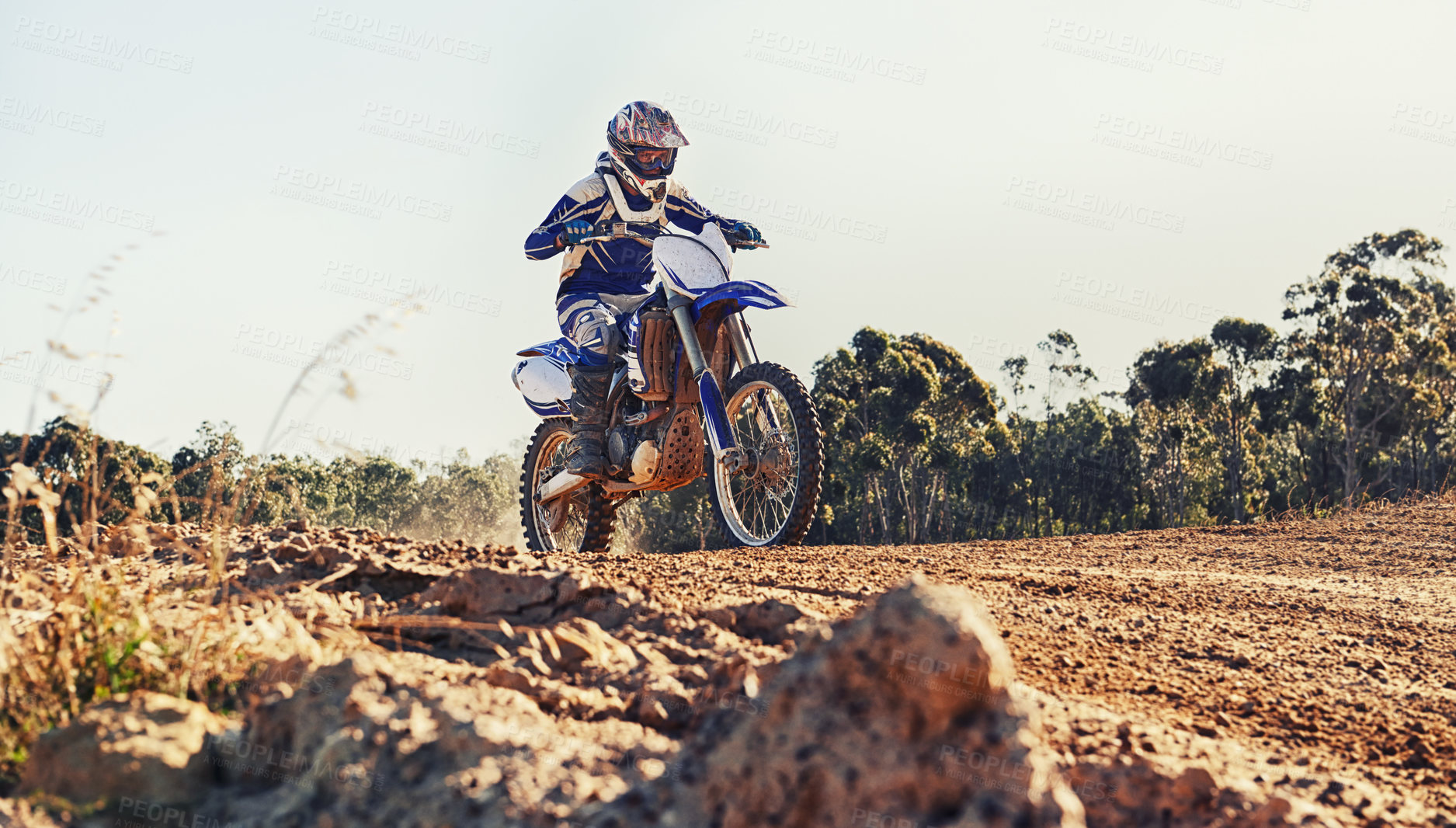 Buy stock photo Stunt, race and man on dirt bike in desert with adventure, adrenaline and speed in competition, Extreme sport, trick and athlete on off road motorcycle for challenge, power or danger on action course