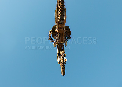 Buy stock photo Motorcycle, jump and person on blue sky mockup with low angle for performance, extreme sports stunt and adrenaline. Competition, fearless and man on motorbike for outdoor challenge and skill.