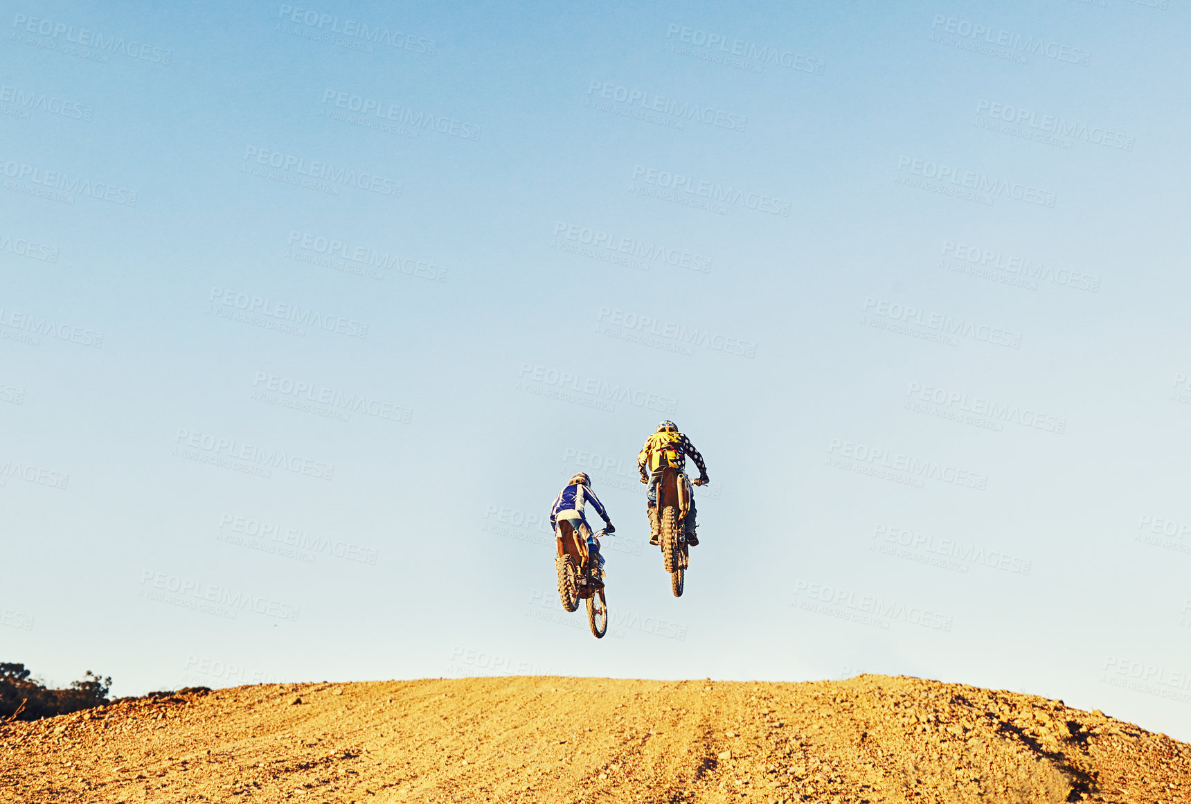 Buy stock photo Rear view, racer and motorcycle in action for competition on dirt road with performance, challenge and adventure. Motocross, motorbike or dirtbike driver with jump stunt on offroad course for racing