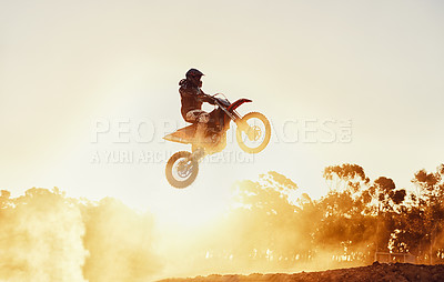 Buy stock photo A shot of a motocross rider in midair during a race