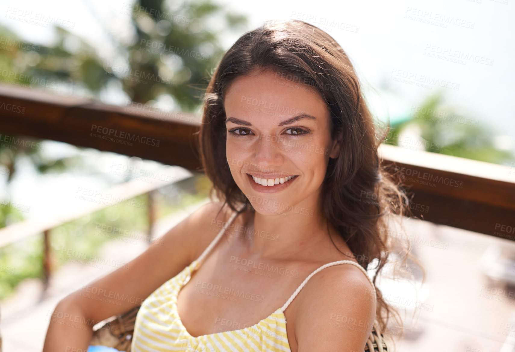 Buy stock photo Portrait of a young woman sitting and relaxing outside on holiday