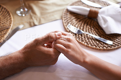 Buy stock photo Holding hands, couple and table for support with love in restaurant for care, affection and leisure for bonding. Relationship, trust and together with committed for unity, relax and conversation.