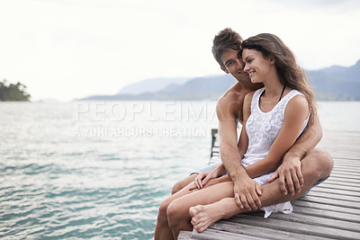 Buy stock photo Couple, jetty and hug by ocean on vacation, love and relax by water on summer holiday. People, embrace and bonding for relationship in outdoors, support and smile on weekend trip to sea or nature