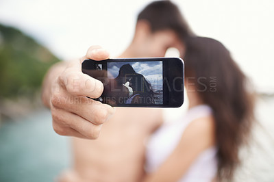 Buy stock photo Couple, phone screen and selfie on beach, travel and love on honeymoon vacation. Happy man, woman and cellphone picture for holiday memories, social media and adventure overseas to seaside Bali 