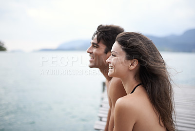 Buy stock photo Couple, jetty and travel to ocean on adventure, love and relax by water on summer holiday. People, swimwear and bonding for relationship in outdoor, support and smile on weekend trip to sea or nature