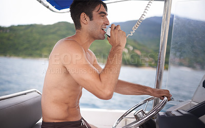 Buy stock photo Man, boat and sailing ocean with radio communication or navigation on coastal water or direction, location or voyage. Male person, steering wheel and marine conversation at sea, transport or nautical