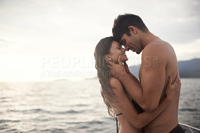 Buy stock photo Love, smile and couple at ocean at sunset for vacation, holiday or travel together in summer. Happy man, woman and hug at sea for connection, care and touch forehead on adventure by water on mockup