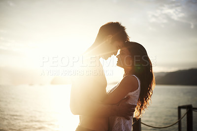 Buy stock photo Sunset, couple and touch face at ocean for holiday, vacation or travel together in summer on lens flare. Happy man, woman and romance at sea for connection, care or love on adventure by water outdoor