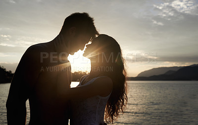 Buy stock photo Silhouette, couple and love by ocean at sunset, vacation or travel together in summer. Man, woman and romance at sea with shadow for connection, relationship and adventure by water outdoor in nature
