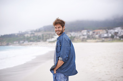 Buy stock photo Portrait, beach and man with a smile, vacation and summer holiday with weekend break and water. Waves, face and person with happiness and guy with seaside and travel with peace and wind with nature