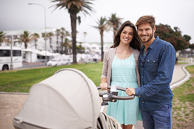 Buy stock photo Portrait, smile and couple on walk with stroller for baby, together and happiness for family. Parents, mother and father outdoor for fresh air in nature for infant, newborn and young child in street