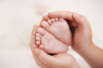 Buy stock photo Cropped shot of mother holding her babies feet