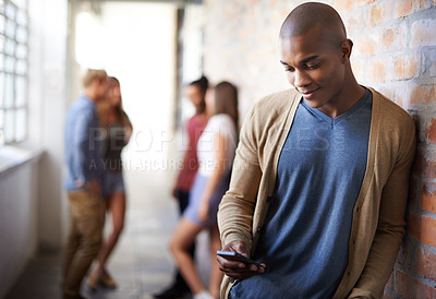 Buy stock photo Shot of a young man sending a text message