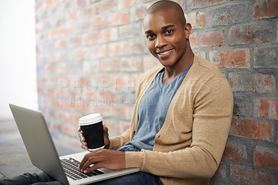 Buy stock photo Cropped shot of a handsome young man working on a laptop