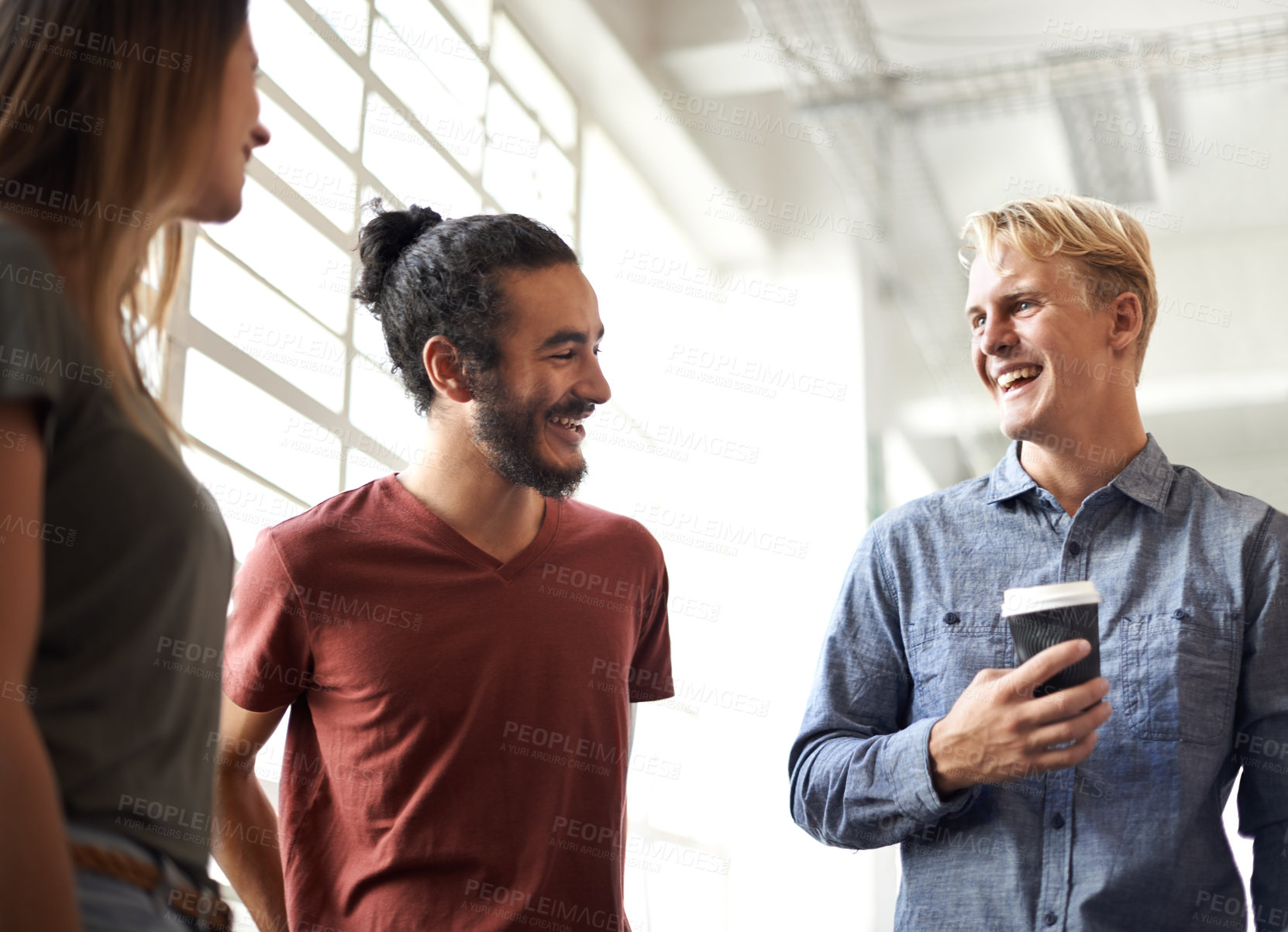 Buy stock photo Laughing, students and coffee in a college hallway for discussion, happiness and a drink. Group of men and a woman as friends at campus or university for a funny chat or conversation about education