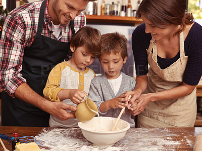 Buy stock photo Family, smile and kids baking in kitchen, learning or happy boys bonding together with parents in home. Father, mother or children cooking with flour, food and brothers pour milk in bowl at table