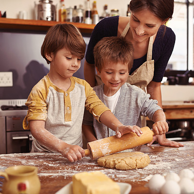 Buy stock photo Cropped shot of two young brothers baking in the kitchen