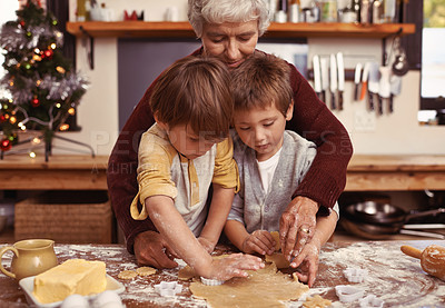 Buy stock photo Grandmother, learning and kids baking at Christmas in kitchen, teaching and boys bonding together in family home. Grandma, children and cooking at xmas and brothers making cookies on holiday at table
