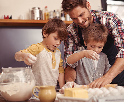 Buy stock photo Cropped shot of two young brothers baking in the kitchen