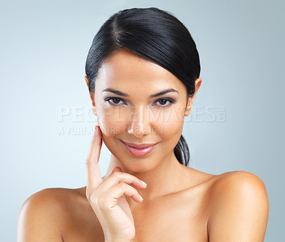 Buy stock photo Studio shot of a beautiful young woman against a blue background