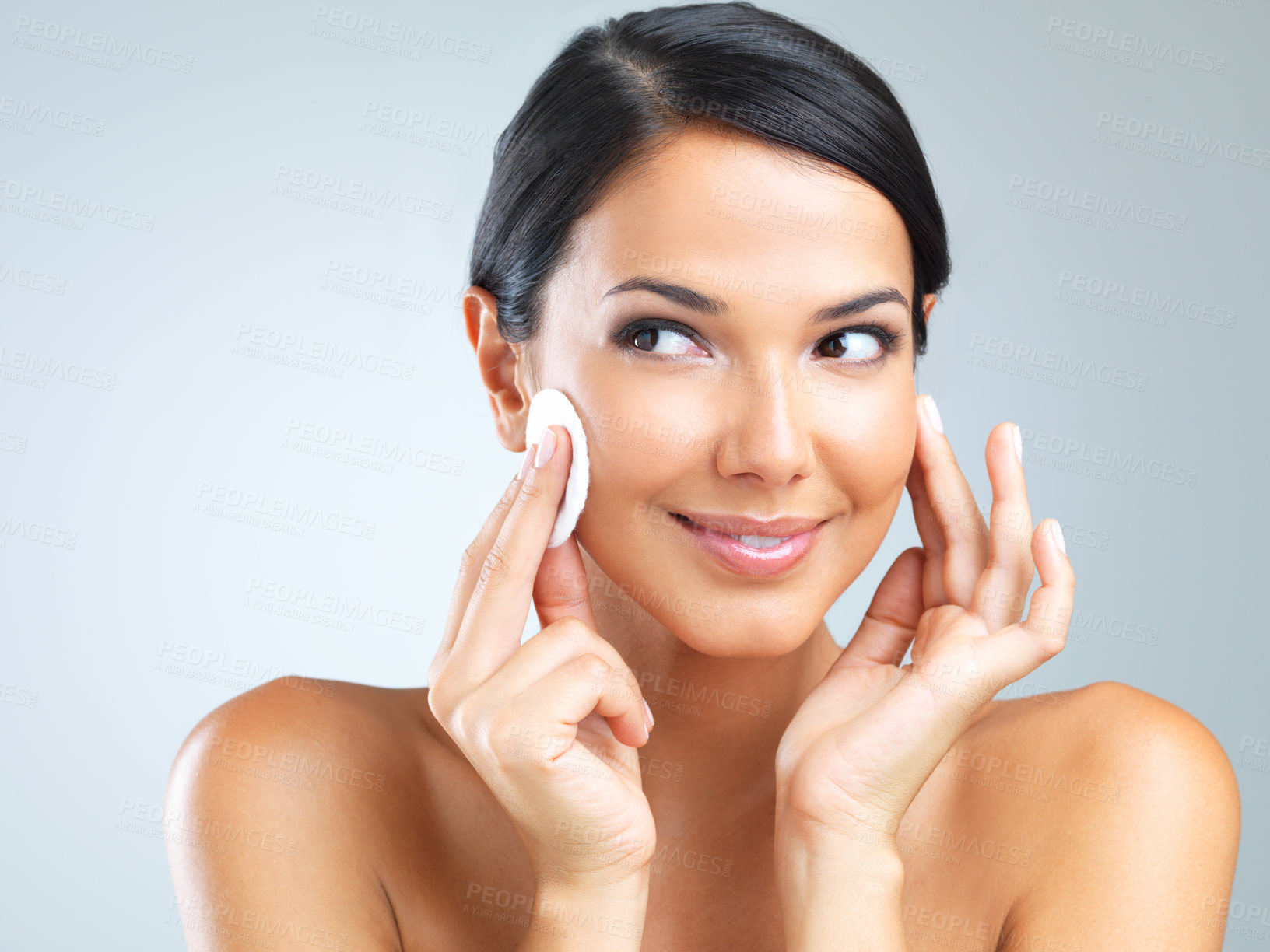 Buy stock photo Cotton pad, beauty and woman cleaning makeup from face, dermatology and skincare with facial on grey background. Cosmetic product, healthy skin and wipe for cleanse, wellness and glow in studio
