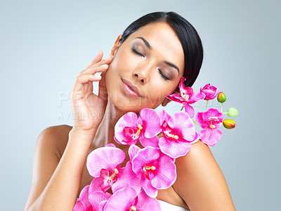 Buy stock photo Woman, flower and smile for beauty, cosmetology and natural makeup on light grey background. Plant, healthy female person and glow for eco friendly, organic and green cosmetics for wellness or pamper