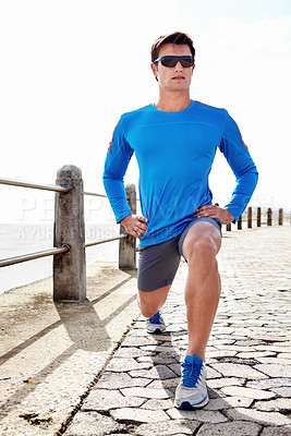 Buy stock photo Man, ocean and stretching for fitness with workout to jog, health and wellness with body care in Chicago. Male person, sportswear and active as runner with sunglasses for exercise, beach or committed