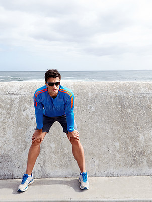 Buy stock photo Man, ocean and stretching for fitness with confidence for workout, health and wellbeing in Chicago. Male person, sportswear and active as runner with exercise at beach and committed with sunglasses.