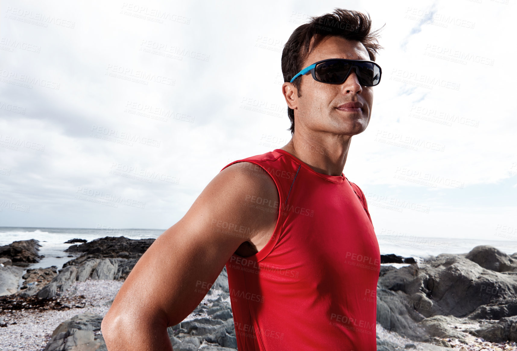 Buy stock photo Man, confidence and beach for fitness, health and wellness in activewear, sunglasses and cloudy sky. Male, jog and seaside for sport, training in nature for workout or exercise for outdoor cardio