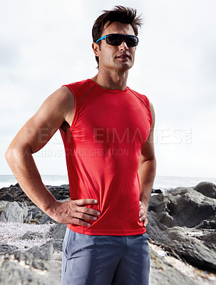 Buy stock photo Athletic man, confident and beach for fitness, health and wellness in activewear and sunglasses. Male person, jog and seaside for sport, train and triathlon in exercise for cardio outdoor routine 